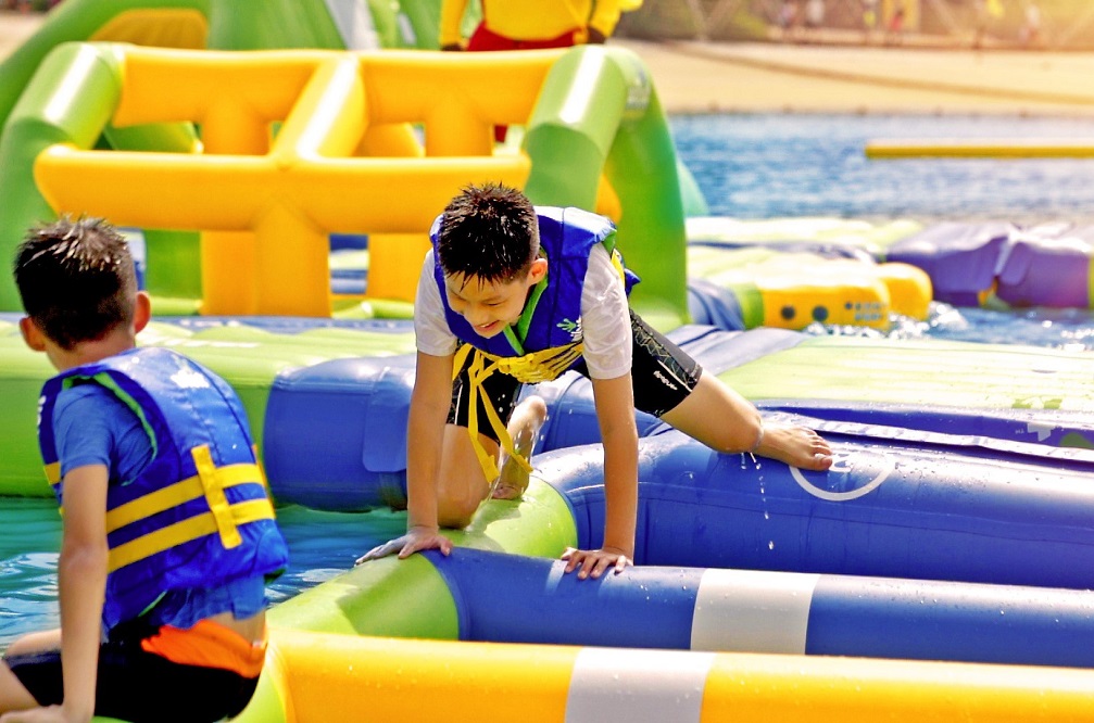 Children playing on a floating obstacle course at Sentosa
